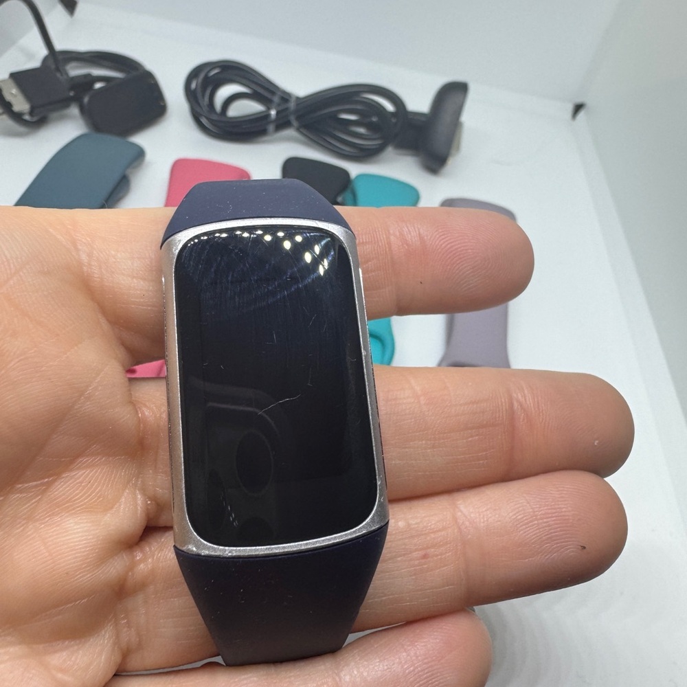 Fitbit Charge 5 with multiple bands and chargers